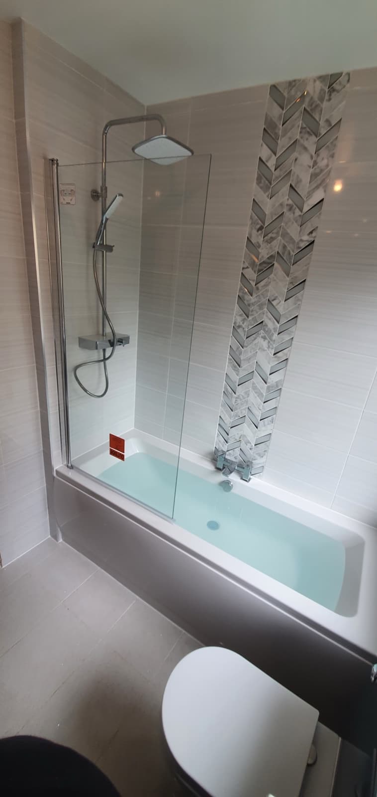 Bathtub install with herringbone feature tile