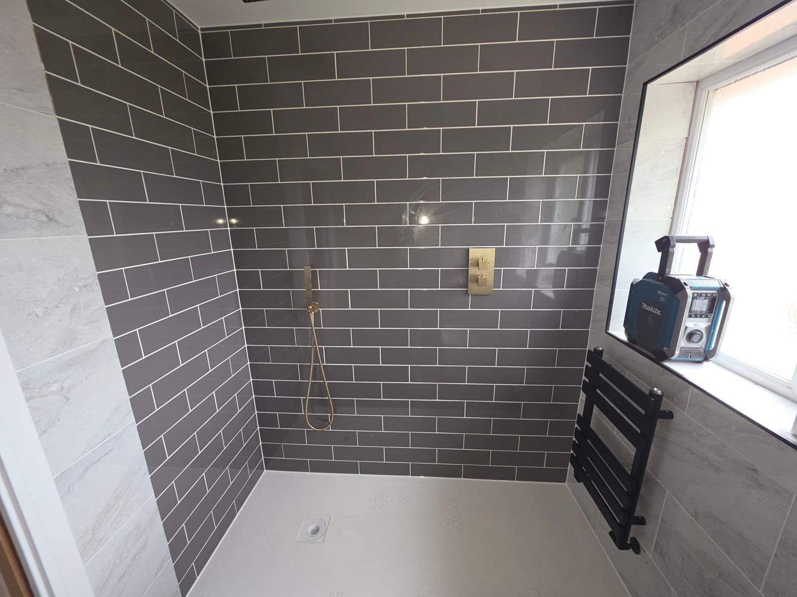 Walk-in shower, dark subway tiling