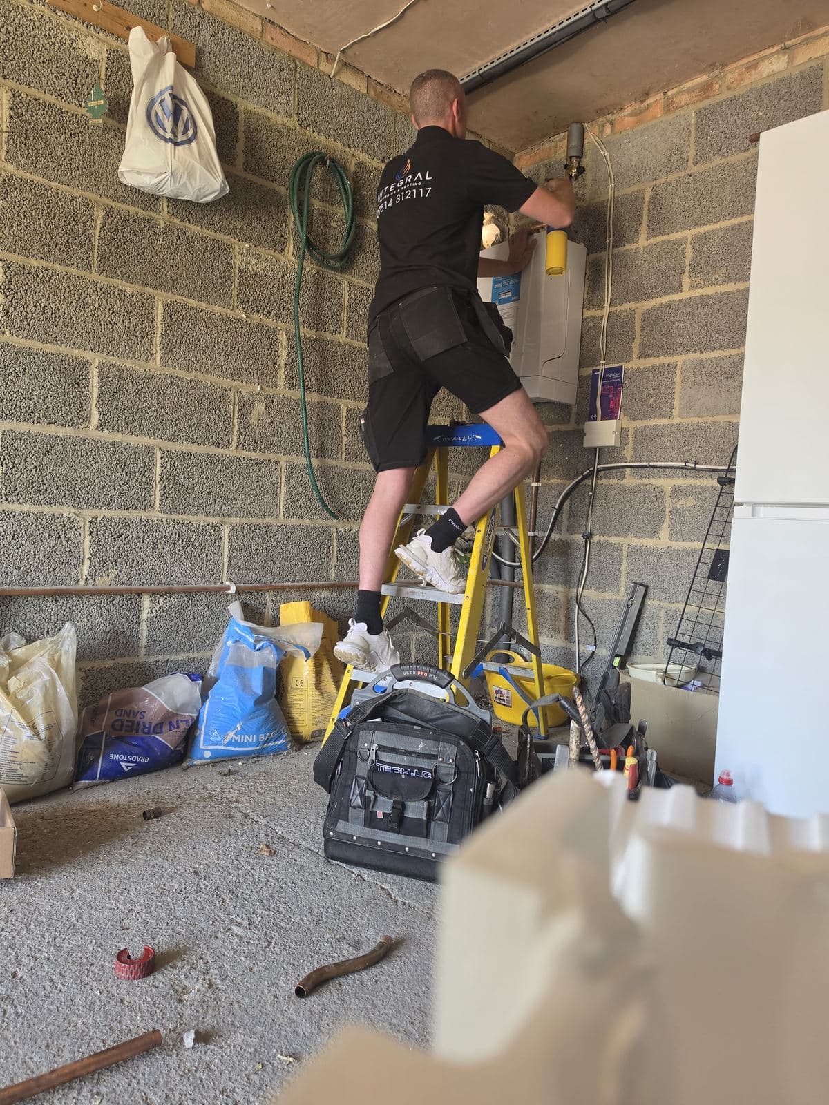 Integral Plumbing and Heating engineer servicing a boiler